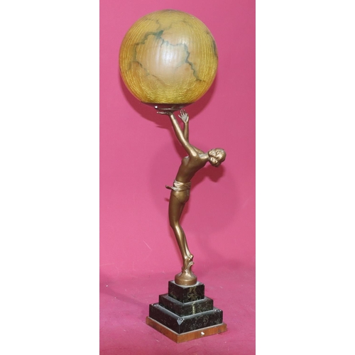 626 - An Art Deco spelter table lamp in the form of a half-naked standing lady holding a circular shade, o... 