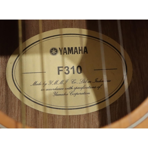 631 - A Yamaha F310 6-string guitar, 103cm high overall