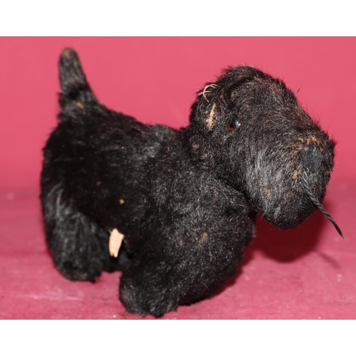 651 - A Chiltern small figure of a black Scottie dog with glass eyes, 22.5cm long