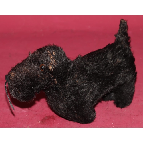 651 - A Chiltern small figure of a black Scottie dog with glass eyes, 22.5cm long