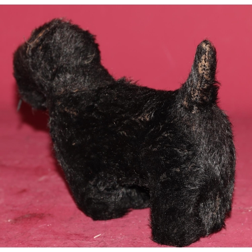 651 - A Chiltern small figure of a black Scottie dog with glass eyes, 22.5cm long