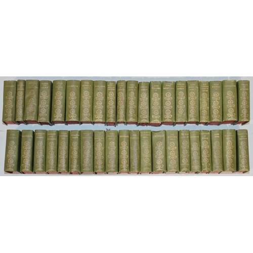 685 - A set of 40 miniature William Shakespeare green bound books in miniature revolving square bookcase, ... 