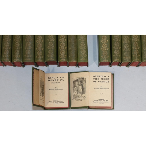 685 - A set of 40 miniature William Shakespeare green bound books in miniature revolving square bookcase, ... 