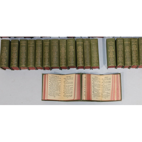 685 - A set of 40 miniature William Shakespeare green bound books in miniature revolving square bookcase, ... 