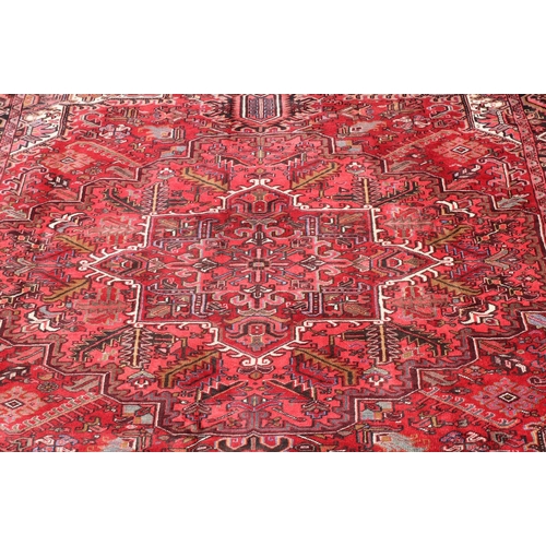 686 - A Persian carpet on red ground with centre medallion, 391cm x 300cm