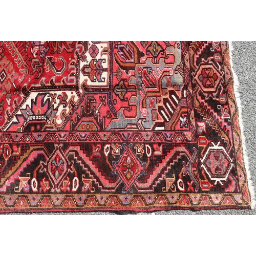 686 - A Persian carpet on red ground with centre medallion, 391cm x 300cm