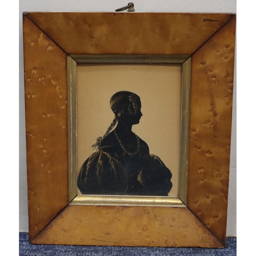 689 - A 19th Century silhouette shoulder length portrait of a young lady with gilt outline decoration, in ... 