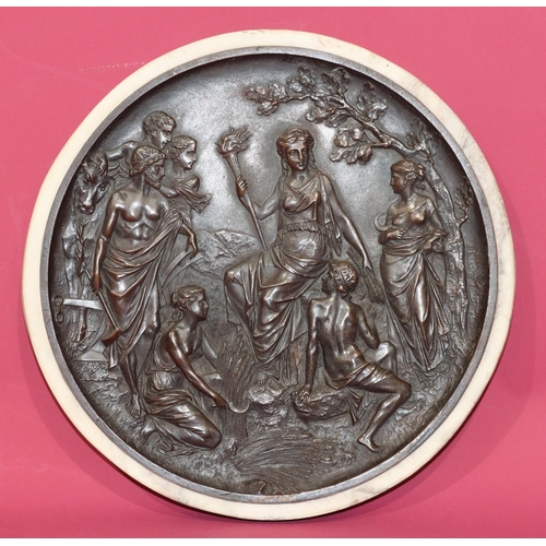 712 - A reproduction circular bronze plaque with raised figure decoration, 22cm diameter