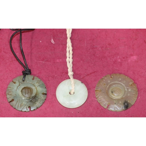 713 - A jade style circular disc shaped pendant and 2 similar pendants (3)