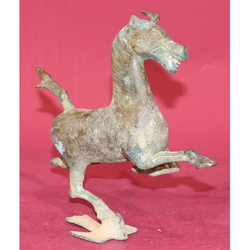 716 - A Continental bronze figure of a running horse, 24.5cm high