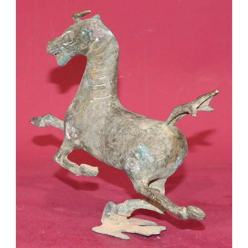 716 - A Continental bronze figure of a running horse, 24.5cm high