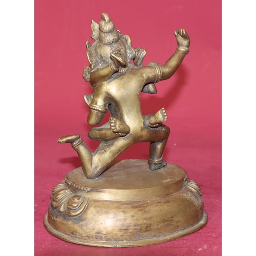 718 - An Eastern gilt bronze erotic group of gentleman and lady on oval base, 22.5cm high