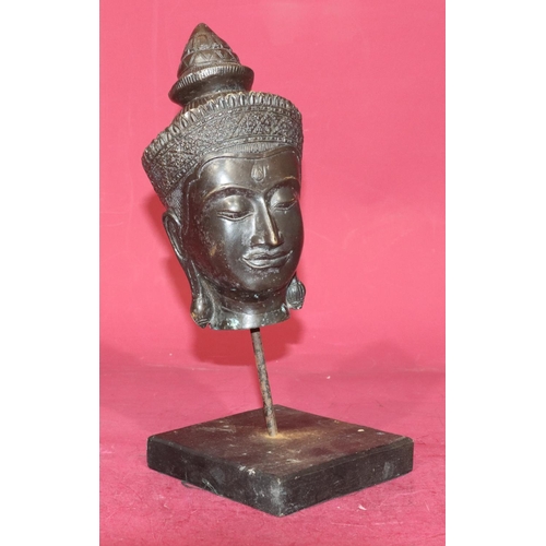 719 - An Eastern bronze figurehead of a lady on later stand and wooden base, 30cm high overall