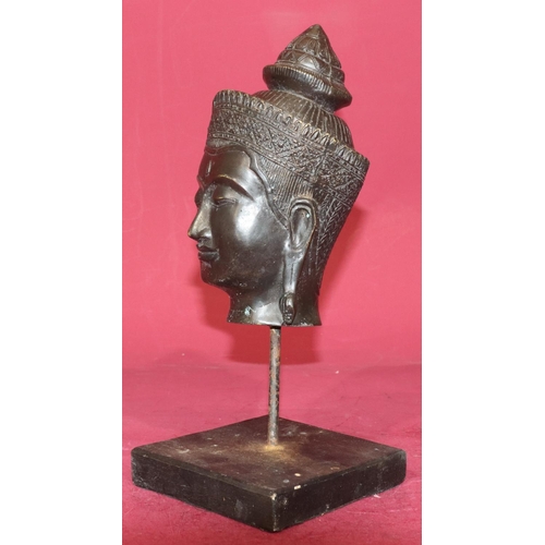 719 - An Eastern bronze figurehead of a lady on later stand and wooden base, 30cm high overall