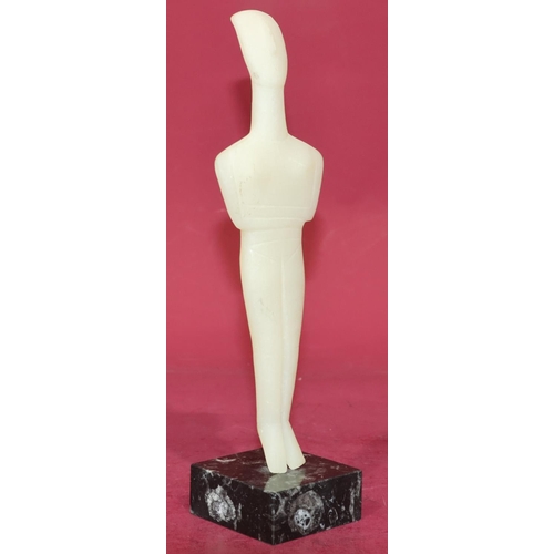 720 - A carved soapstone style figure of a standing gentleman on square black base, 29cm high