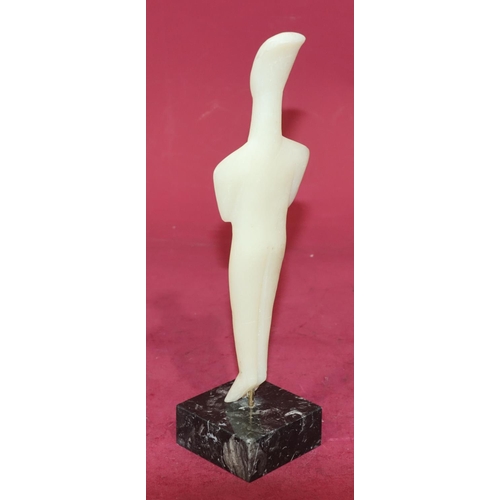 720 - A carved soapstone style figure of a standing gentleman on square black base, 29cm high