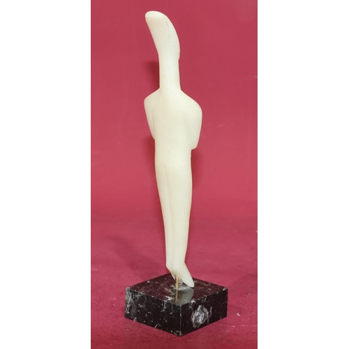 720 - A carved soapstone style figure of a standing gentleman on square black base, 29cm high