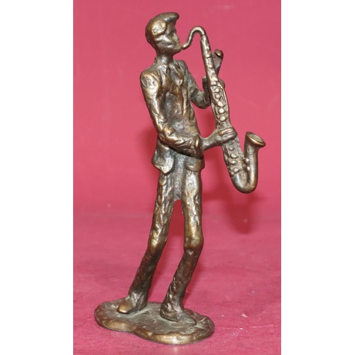 721 - A bronze figure of a saxophonist on scallop shaped base, 21.5cm high