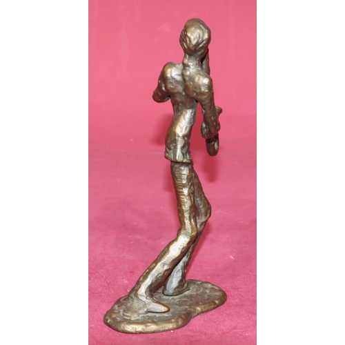 721 - A bronze figure of a saxophonist on scallop shaped base, 21.5cm high