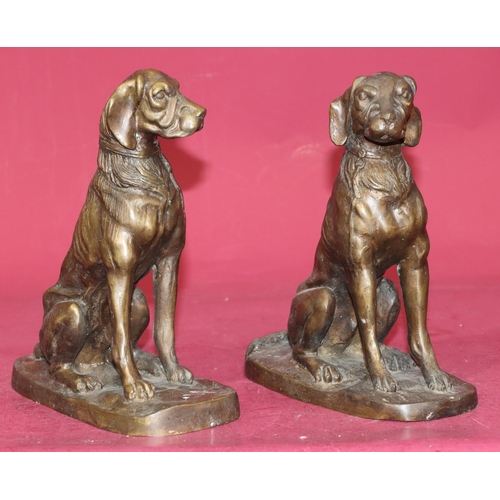 724 - A pair of bronzed figures of seated dogs, 23cm high