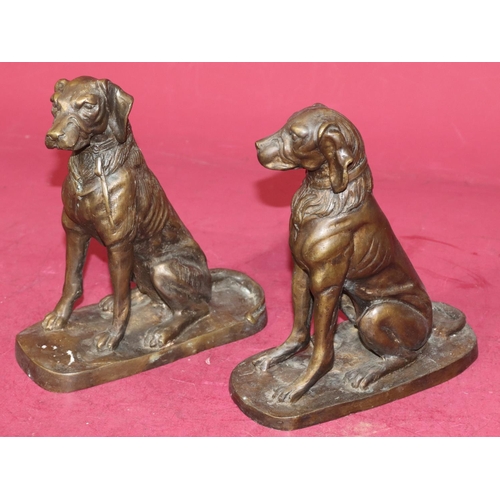 724 - A pair of bronzed figures of seated dogs, 23cm high