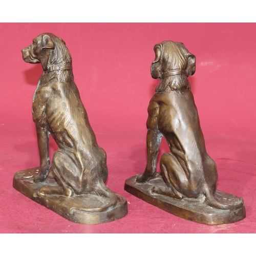 724 - A pair of bronzed figures of seated dogs, 23cm high