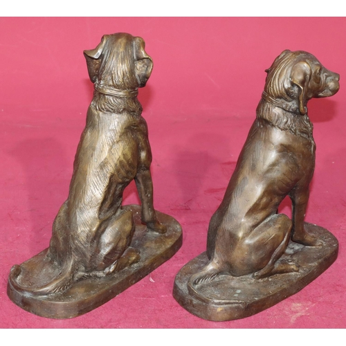 724 - A pair of bronzed figures of seated dogs, 23cm high