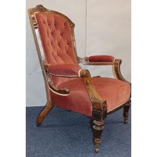 757 - A Victorian walnut spoon back armchair with velvet overstuffed seat, button back and padded arms on ... 