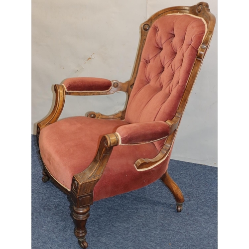 757 - A Victorian walnut spoon back armchair with velvet overstuffed seat, button back and padded arms on ... 