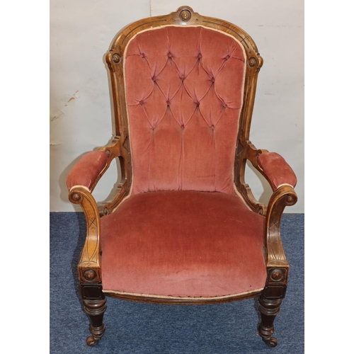 757 - A Victorian walnut spoon back armchair with velvet overstuffed seat, button back and padded arms on ... 