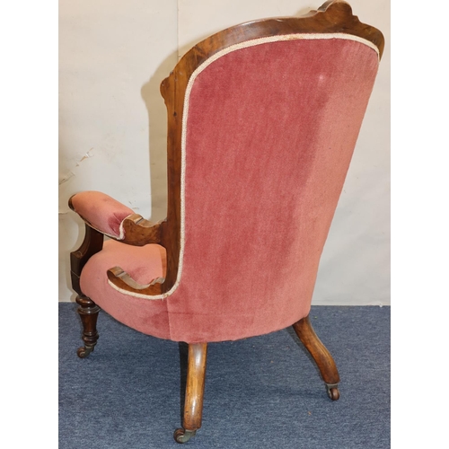 757 - A Victorian walnut spoon back armchair with velvet overstuffed seat, button back and padded arms on ... 