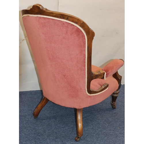 757 - A Victorian walnut spoon back armchair with velvet overstuffed seat, button back and padded arms on ... 