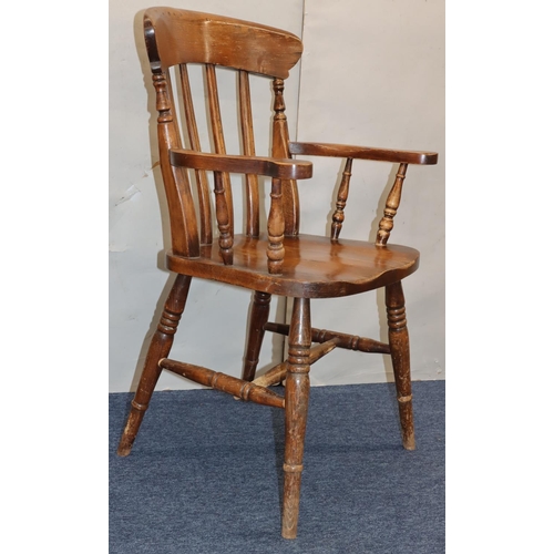 758 - An elm stick back armchair with solid seat on round turned legs