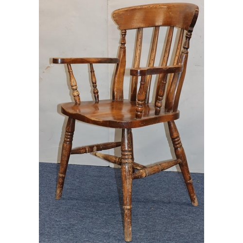 758 - An elm stick back armchair with solid seat on round turned legs