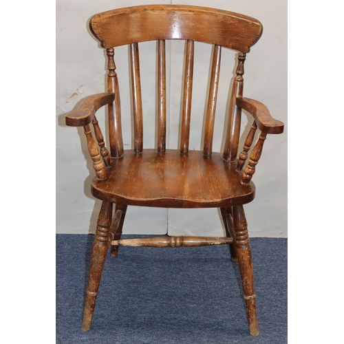 758 - An elm stick back armchair with solid seat on round turned legs