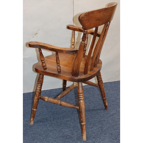 758 - An elm stick back armchair with solid seat on round turned legs