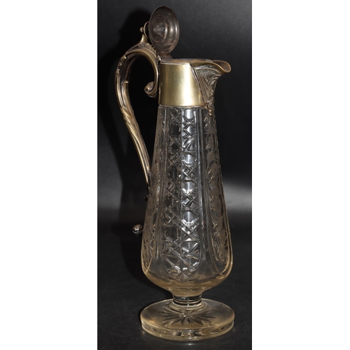 85 - A cut glass round bulbous claret jug with silver plated neck, hinged lid and scroll handle with allo... 