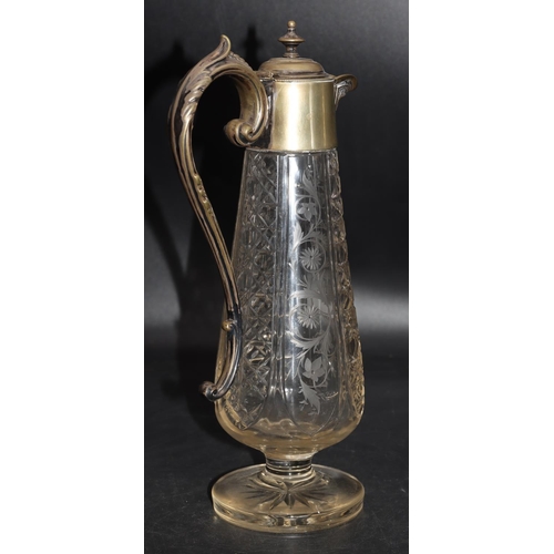 85 - A cut glass round bulbous claret jug with silver plated neck, hinged lid and scroll handle with allo... 