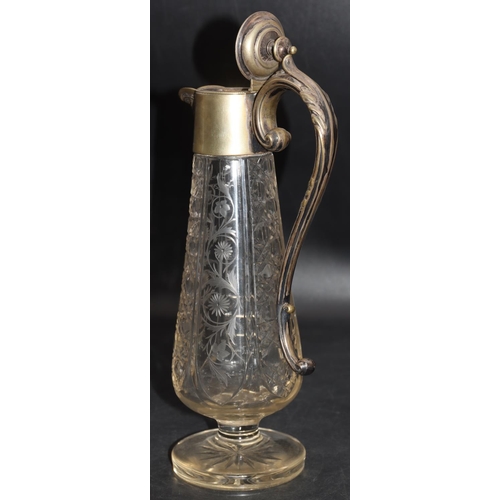 85 - A cut glass round bulbous claret jug with silver plated neck, hinged lid and scroll handle with allo... 