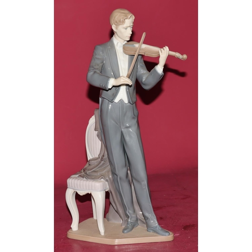 86 - A large Lladro figure of a standing violinist next to a chair, 38.5cm high