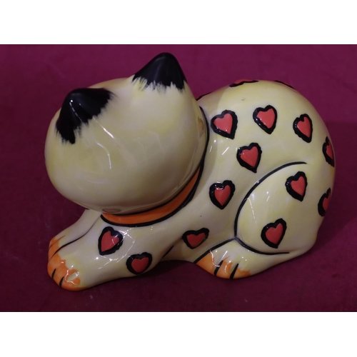 9 - A Lorna Bailey limited edition Art Deco style china figure of a resting cat on yellow, black and red... 