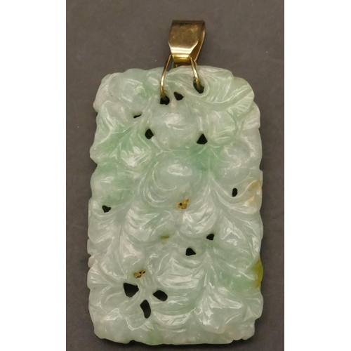 593 - An Oriental jade panel mounted as a pendant with raised bird, floral and scroll decoration, 6.5cm hi... 