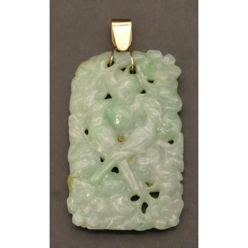 593 - An Oriental jade panel mounted as a pendant with raised bird, floral and scroll decoration, 6.5cm hi... 