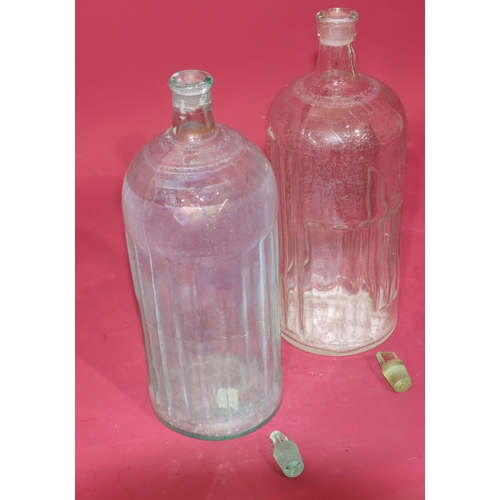 7211 - A clear glass Poison bottle with stopper, 34.5cm high and another similar bottle (2)