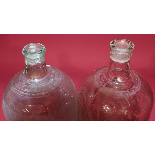 7211 - A clear glass Poison bottle with stopper, 34.5cm high and another similar bottle (2)