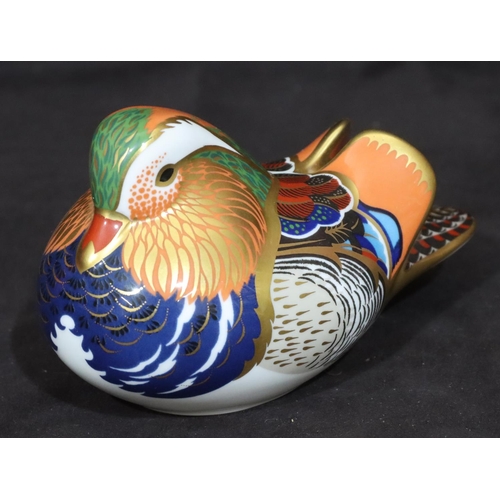 115 - A Royal Crown Derby paperweight in the form of a bird, with silver coloured stopper, 7.5cm high, 12.... 