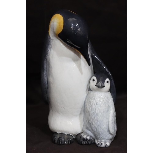 120 - A Royal Copenhagen model of a penguin with chick, numbered 077, monogrammed MR, 22cm high