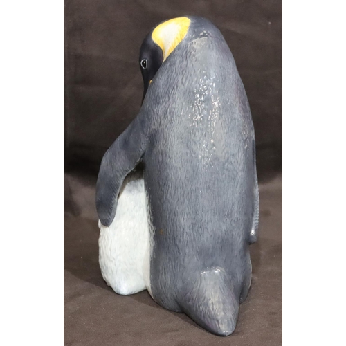 120 - A Royal Copenhagen model of a penguin with chick, numbered 077, monogrammed MR, 22cm high