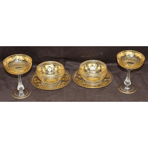 122 - A pair of clear cut glass champagne glasses with gilt, floral and leaf decoration and a pair of simi... 