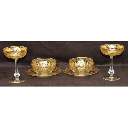 122 - A pair of clear cut glass champagne glasses with gilt, floral and leaf decoration and a pair of simi... 